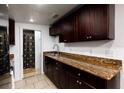 Well-lit kitchen featuring granite countertops, dark wood cabinets, stainless steel faucet and shower view at 331 25Th S St, St Petersburg, FL 33712