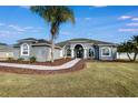 Elegant home with a manicured lawn, a curving walkway, and stunning curb appeal at 9413 Swift Creek Cir, Dover, FL 33527