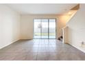 Bright living room with sliding glass door to the backyard, showcasing the open and airy layout at 32535 Turtle Grace Loop, Wesley Chapel, FL 33545