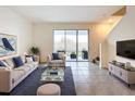 Comfortable living room with stylish furnishings and a sliding glass door to the outdoor patio at 32535 Turtle Grace Loop, Wesley Chapel, FL 33545