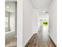 Long hallway with wood floors leads to the open living spaces and bedrooms at 5283 Everlong Dr, Apollo Beach, FL 33572