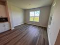 Bright room featuring plank floors, neutral paint, and a large window overlooking a green field at 4319 Pullet Ct, Bradenton, FL 34211
