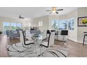 Open concept living and dining room features stylish furniture, modern lighting, and water views at 12077 Gandy N Blvd # 344, St Petersburg, FL 33702