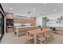 Bright, eat-in kitchen featuring wood cabinetry, modern appliances, island with seating, and natural lighting at 2517 N Riverside Dr, Tampa, FL 33602