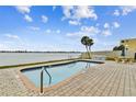 Enjoy this inviting community pool with waterfront views of the intercoastal waterway, a tranquil escape at 800 Madonna Blvd # 2, Tierra Verde, FL 33715