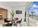 Bright dining area featuring tile floors, modern furniture and large windows with a beautiful view at 800 Madonna Blvd # 2, Tierra Verde, FL 33715