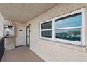 Hallway shows exit, emergency equipment, and large window at 19450 Gulf Blvd # 401, Indian Shores, FL 33785