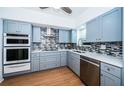 Modern kitchen featuring stainless steel appliances, sleek cabinetry, and stylish backsplash at 2258 World Parkway W Blvd # 8, Clearwater, FL 33763