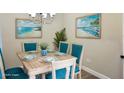 Cozy dining room with seating for six, beach decor, and ample natural light at 5426 Rushmere Ct, Palmetto, FL 34221
