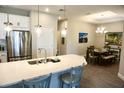 Modern kitchen with stainless steel appliances, quartz countertops, and an open floor plan at 5426 Rushmere Ct, Palmetto, FL 34221