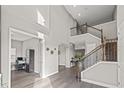 Open-concept foyer featuring hardwood floors, high ceilings and a staircase with iron railing at 6307 Brevada Ln, Apollo Beach, FL 33572