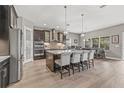 Spacious kitchen with a large center island, modern appliances, and a breakfast bar seating four at 6307 Brevada Ln, Apollo Beach, FL 33572
