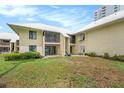 A Two-story condo building with a screen lanai and large sliding doors to the backyard at 7300 Sunshine Skyway S Ln # 108, St Petersburg, FL 33711