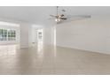 Bright living room featuring tile floors, ceiling fan, and neutral color scheme for versatile decorating at 1360 Franklin Ln, North Port, FL 34286