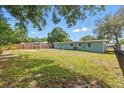 Large backyard with a well-maintained lawn and privacy fence, perfect for outdoor activities at 1415 Ridge Ave, Clearwater, FL 33755