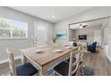 Bright dining room featuring an open floor plan, wood floors, and a view into the living room at 1415 Ridge Ave, Clearwater, FL 33755