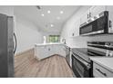 Spacious eat-in kitchen with stainless steel appliances and large windows offering natural light at 1946 Hammocks Ave, Lutz, FL 33549