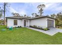 Well maintained home boasts lush green lawn, complemented by fresh landscaping at 1150 Huntington St, North Port, FL 34288