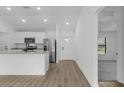 Bright kitchen features granite countertops, stainless steel appliances, and wood flooring at 1150 Huntington St, North Port, FL 34288