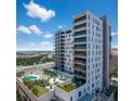 Stunning exterior view of a modern high-rise condo building with multiple balconies and a rooftop pool and lounge area at 199 Dali Blvd # 407, St Petersburg, FL 33701