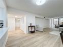 Bright living room with hardwood floors, closet space, and natural light at 220 Belleview Blvd # 101, Belleair, FL 33756