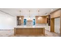Bright kitchen featuring a large center island, custom cabinetry, and pendant lighting at 2622 N Dundee St, Tampa, FL 33629