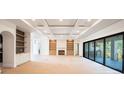 Open living room featuring a fireplace, built-in shelving, and sliding glass doors at 2622 N Dundee St, Tampa, FL 33629