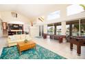 Spacious living room with bar, tile floors, and expansive windows offering water views at 301 Midway Is, Clearwater Beach, FL 33767