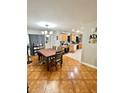 Inviting dining room adjacent to kitchen with stylish chandelier and modern furnishings at 37634 Hidden Park Ct, Dade City, FL 33525
