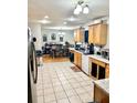 Bright kitchen with wooden cabinetry, stainless steel appliances, and an open layout to dining area at 37634 Hidden Park Ct, Dade City, FL 33525