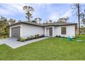 This charming home features a well-maintained lawn and thoughtful landscaping at 4621 Kenoska St, North Port, FL 34288