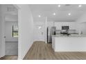 Open-concept kitchen featuring stainless steel appliances, granite countertops, and modern fixtures at 4621 Kenoska St, North Port, FL 34288