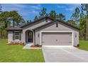 Attractive single-story home with a two-car garage, neutral color palette, and well-maintained landscaping at 7220 Swartburg Rd, North Port, FL 34291