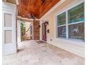 Charming front porch featuring stone accents, wood ceilings, and a tiled floor at 310 8Th N Ave, St Petersburg, FL 33701