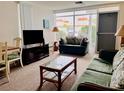 Cozy living room with comfortable seating and ample natural light at 4352 Tahitian Gardens Cir # E, Holiday, FL 34691