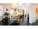 Bright dining room with black tile floor, modern light fixture, and stylish furniture at 4056 18Th S Ave, St Petersburg, FL 33711