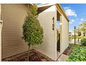 Condo exterior displaying unit number and entryway stairs, complemented by a beautiful lakeside view at 4154 Pinelake Ln # 101, Tampa, FL 33618