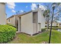 Attractive exterior with a private yard, beautiful plants, and access to a serene pond, ideal for outdoor enjoyment at 4154 Pinelake Ln # 101, Tampa, FL 33618