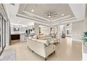 Spacious living room with high ceilings, tile floors, and an open floor plan to the kitchen at 30715 Tumbleberry St, Wesley Chapel, FL 33543