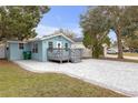 Charming light blue home with a cozy front porch and an inviting paved driveway at 5161 Rena N St, St Petersburg, FL 33709