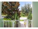 Inviting entrance with lush landscaping and a charming white picket fence at 11125 Winthrop Lake Dr, Riverview, FL 33578