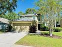 Inviting home with a well-manicured lawn and a spacious two-car garage at 12127 Luftburrow Ln, Hudson, FL 34669