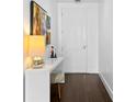Hallway features include a sleek white console table, modern art, and dark wood flooring, all leading to a closed door at 301 1St S St # 3204, St Petersburg, FL 33701