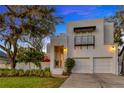 Beautiful home with manicured lawn, two car garage, and modern architectural details at 4845 W Sunset Blvd, Tampa, FL 33629