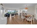 Open-concept living space with natural light, leading to a modern kitchen and cozy dining area at 7537 Bayshore Dr # 406, Treasure Island, FL 33706
