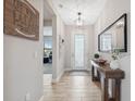 Bright hallway with wood-look tile flooring and access to living spaces at 14786 Horse Trot Rd, Lithia, FL 33547