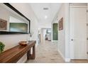 Inviting hallway with wood-look tile flooring and stylish decor at 14786 Horse Trot Rd, Lithia, FL 33547