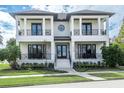 A stunning two-story home featuring a symmetrical facade, beautiful columns, and a well-manicured lawn and landscape at 200 Cordova Ne Blvd, St Petersburg, FL 33704
