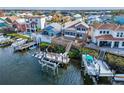 Aerial view featuring a waterfront home's backyard, multiple docks, and boat lifts ready for aquatic adventures at 861 Symphony Isles Blvd, Apollo Beach, FL 33572