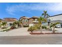 The home features mature landscaping and a large driveway with ample parking in a desirable coastal neighborhood at 861 Symphony Isles Blvd, Apollo Beach, FL 33572